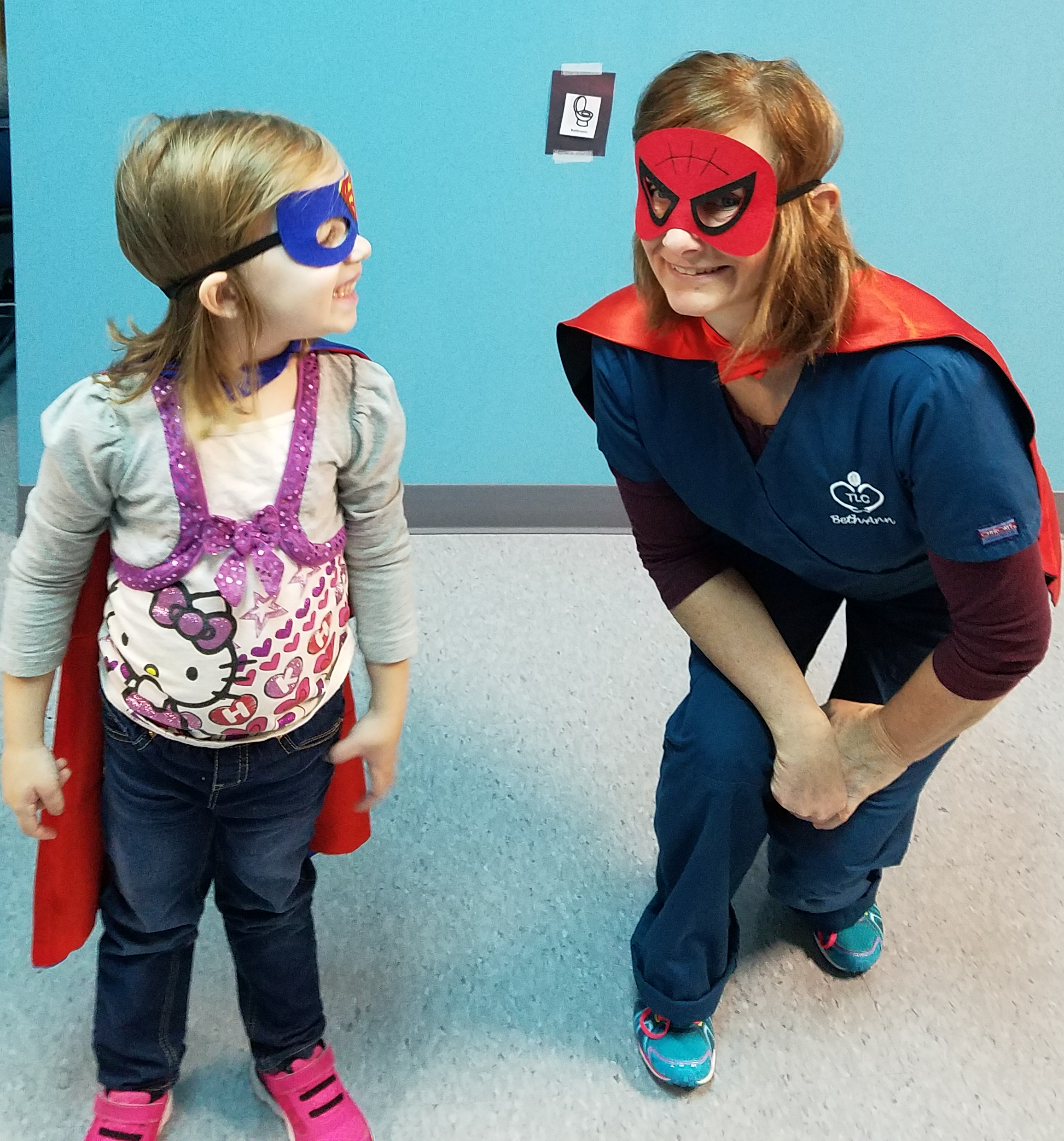 Therapist and child playing superheroes