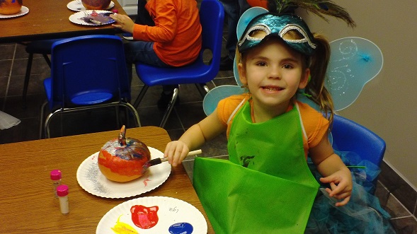 KK painting a pumpkin