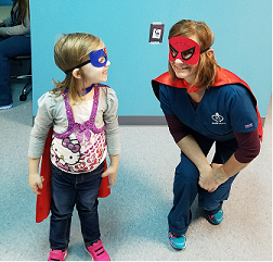 Therapist and girl dressed up as super heroes