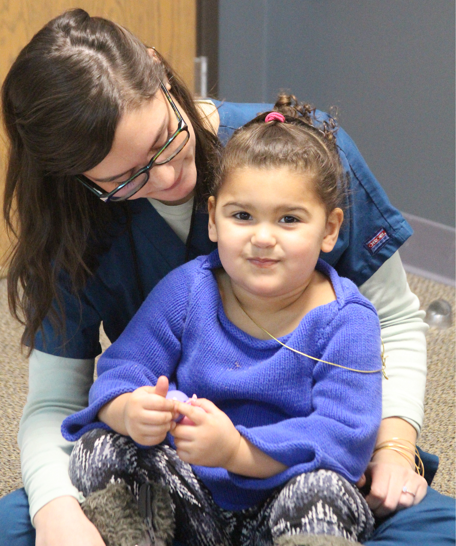 Therapist and girl sitting happily