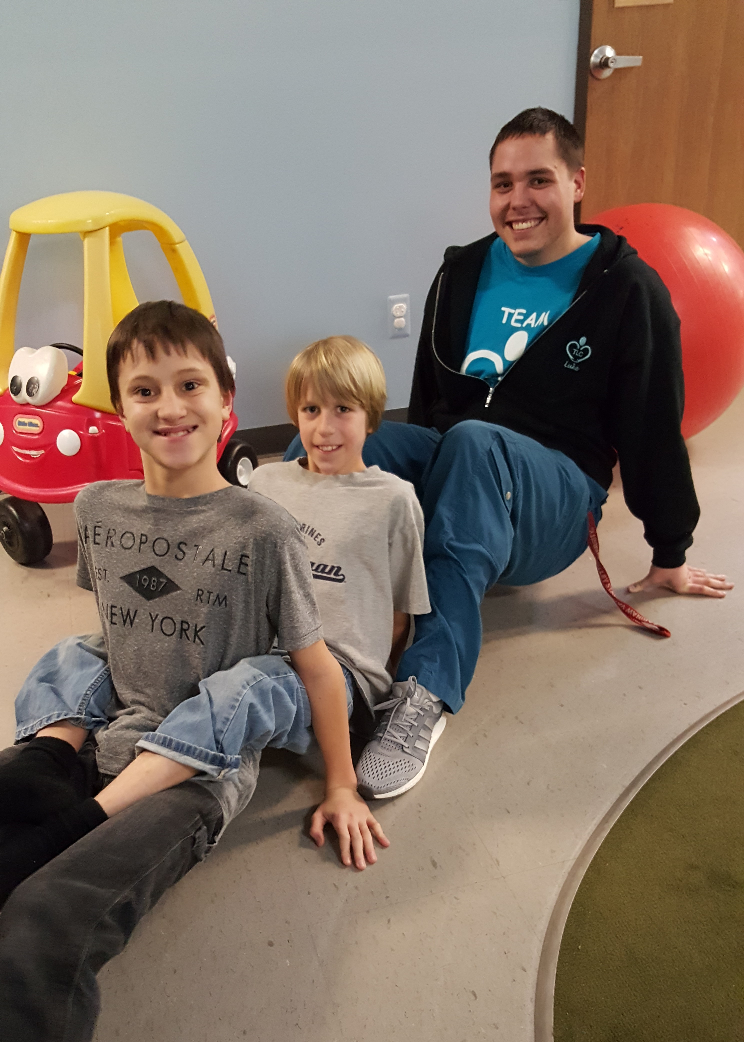 Therapist and two boys working on core strengthening